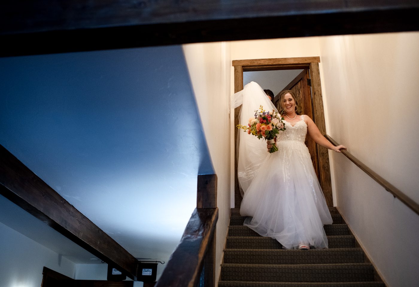 bride-walking-down-blue-stairs